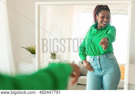 Self Confident Black Woman Pointing Finger At Her Reflection In Mirror, Dancing And Felling Good, En