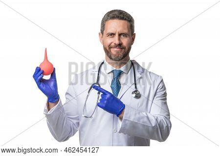 Doctor Hold Enema Isolated On White. Enema For Medical Procedure. Nurse Man Point Finger On Enema