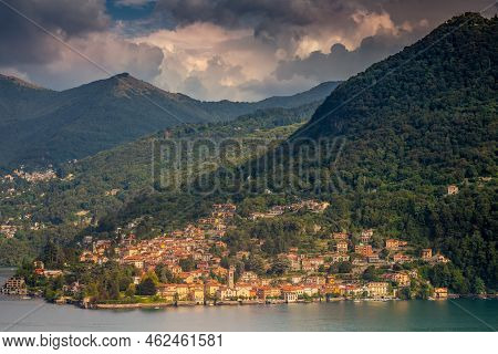 Idyllic Lake Como Coastline With Village And Boat At Dramatic Sunset, Northern Italy