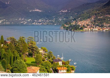 Idyllic Lake Como Coastline With Village And Boat At Dramatic Sunset, Northern Italy