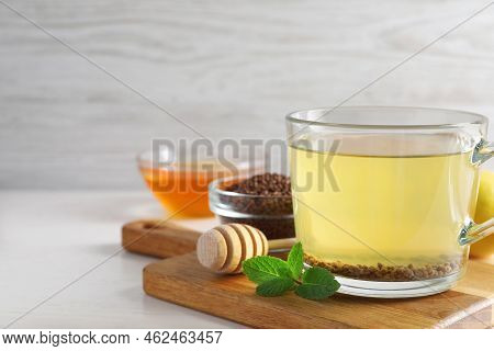 Cup Of Aromatic Buckwheat Tea, Mint, Honey And Granules On White Table, Space For Text