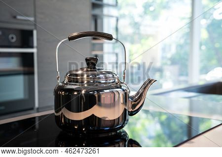 Stainless Water Crow Or Vintage Kettle Tea Pot On Electronic Stove In Modern Kitchen Room.