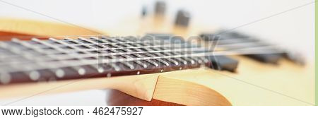Close-up Of Luxury Wavy Shape Of Wooden Electric Guitar With Rosewood Neck. Six Stringed Musical Ins