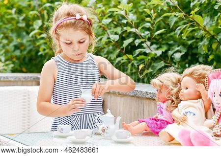 Little Preschool Girl Playing With Dolls. Happy Excited Child Play Tea Party With Toys. Role Games F