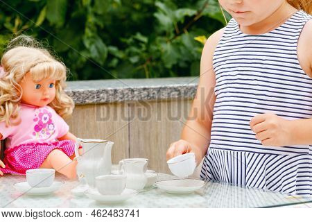 Little Preschool Girl Playing With Dolls. Happy Excited Child Play Tea Party With Toys. Role Games F