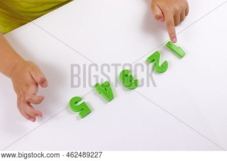 Child Math Development, Learning Center, Sorting Skills Concept. Child's Hands With Numbers. Number 
