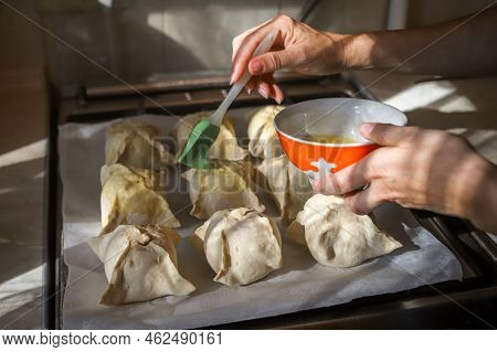Making Apples Baked In Dough. Closeup Of Woman's Hands Spreading Egg Yolk With Silicone Culinary Bru