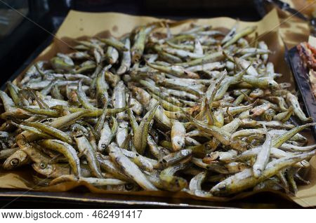 Delicious Fried Anchovy Small Fish For Sale. Fresh Salty Dish. The Concept Of Italian Street Food. S