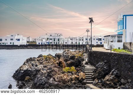 White Architecture On Black Volcanic Rocks In Corralejo, Lanzarote, Spain