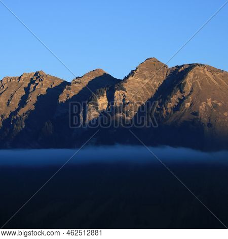 Mountain At Sunrise And Fog Belt. Scene In Gsteig Bei Gstaad.