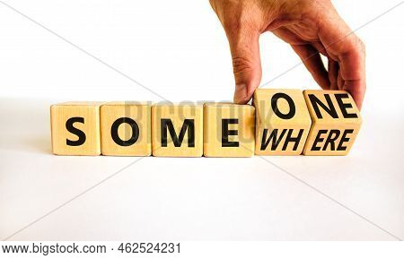 Someone Somewhere Symbol. Businessman Turns Wooden Cubes And Changes The Concept Word Someone To Som