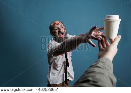 Spooky Horror Monster Wanting Cup Of Coffee, Chasing After Hand With Carton Cup With Drink. Aggressi