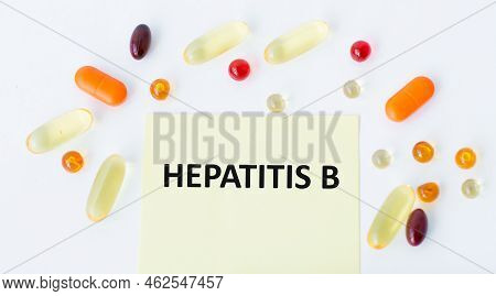 Hepatitis B Inscription On A Yellow Card On A Light Background Around Scattered Tablets