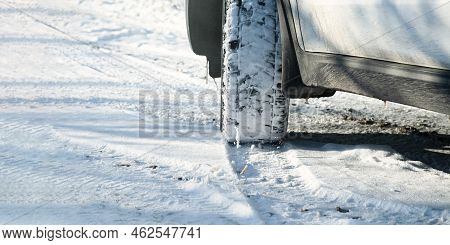 Car Wheels Snow Close-up. Driving On A Winter Road. Winter Tires Shooting From A Lower Angle. The Co
