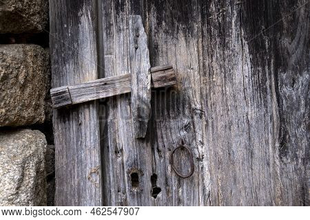 Old Unvarnished Wooden Door Deteriorated By The Weather