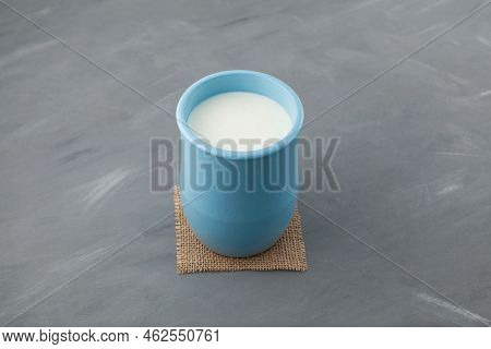 Fermented Milk Drink. Turkish Drink Ayran Or Kefir In Blue Ceramic Jug On Grey Background. Diet Drin