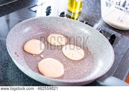 Frying Small Pancakes On A Kefir Base In A Frying Pan.