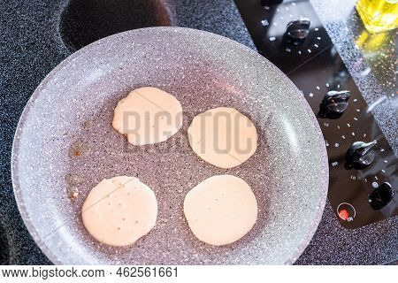 Frying Small Pancakes On A Kefir Base In A Frying Pan.