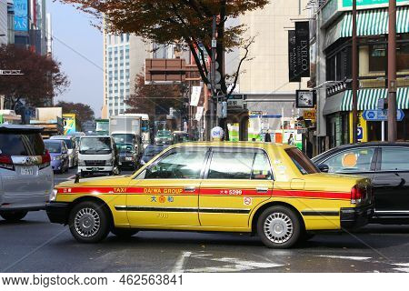 Tokyo, Japan - December 1, 2016: People Ride A Daiwa Group Taxi Cab In Ginza District Of Tokyo, Japa