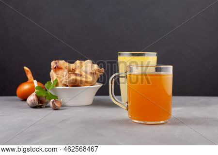 Beef Bone Broth In Glasses On Dark Background, Selective Focus. Bones Contain Collagen, Which Provid