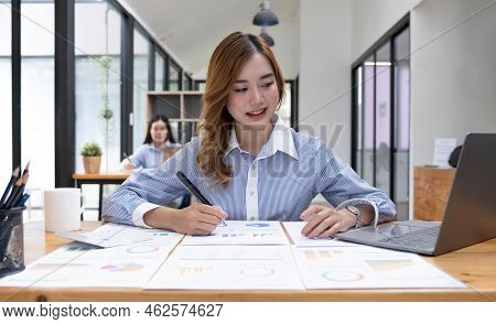 Asian Woman Working On A Laptop Computer, Working In The Office With Laptop Concept, Young Asian Wom