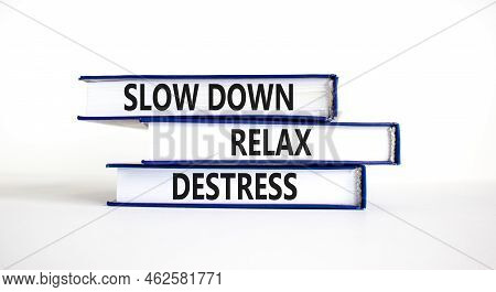 Destress Symbol. Concept Words Slow Down Relax Destress On Books. Beautiful White Table White Backgr