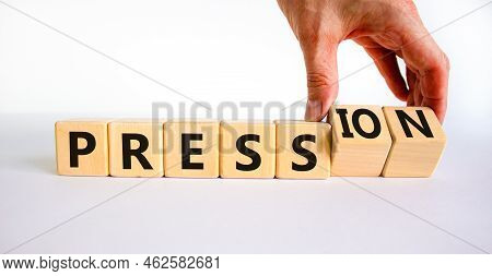Pression To Free Press Symbol. Businessman Turns Wooden Cubes And Changes The Word Pression To Press