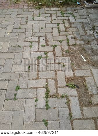 The Expanse Of Dirty And Filthy Conblock Floors In A Garden With A Shooting Angle From Above