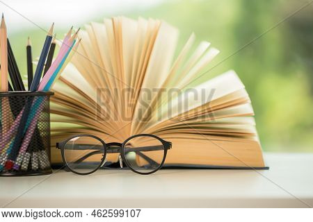 Object Education Green Nature Background With Stack Of Ancient Books Or Old Bible, Open Paper Book O