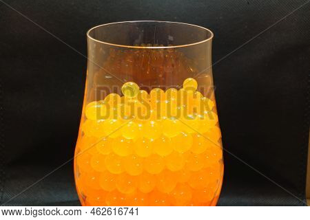 Growing Orbeez In A Glass. Multicolored Balls That Grow In Water.