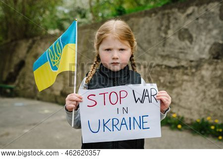Upset Poor Toddler Girl Kid Protesting War Conflict Raises Banner With Inscription Message Text Stop