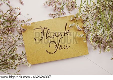 Thank You Written On Paper Card With Flower Frame Decoraton On Pink Background