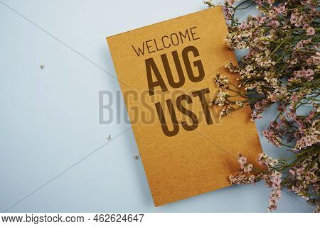 Welcome August Written On Paper Card With Flower Frame Decoraton On Pink Background