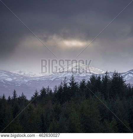 Landscape Image Of Dramatic Winter Storm Sunset Clouds Over The Peaks Of Beinn Toaig And Stob A'choi