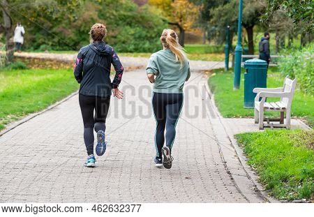 Jette, Brussels Capital Region - Belgium - 11 05 2020 Two Attractive Young Girls Jogging In A City P