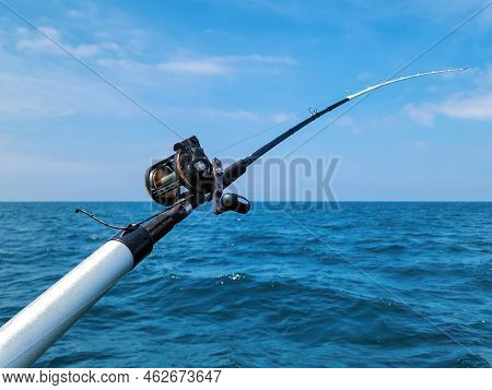 Fishing Rod And Reel On Blue Lake Michigan Water