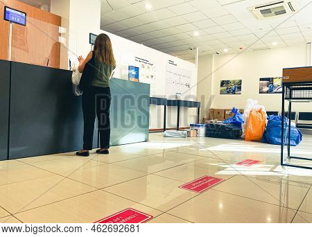 Tbilisi, Georgia - 25 October, 2022: Customer Stand Alone In Post Office By Desk Talk With Postal Se