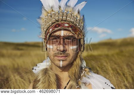 A Man In Traditional Native American Clothing In The Steppe