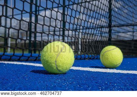 Two Balls Near The Net Of A Paddle Tennis Court, Racket Sports