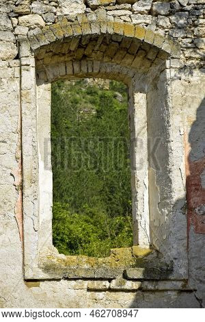 Picturesque View Through Window Of Old Ruined Building. Ruins Of Ancient Synagogue In Rashkov, Moldo