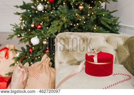 Red Gift Box On The Background Of A Christmas Tree