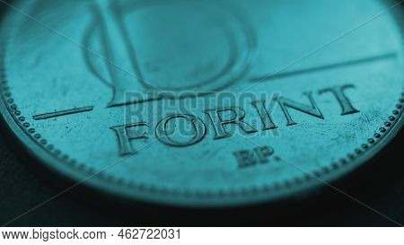 Hungarian Coin Of 10 Forints Lies On Dark Surface Close Up. Money Of Hungary. News About Economy Or 