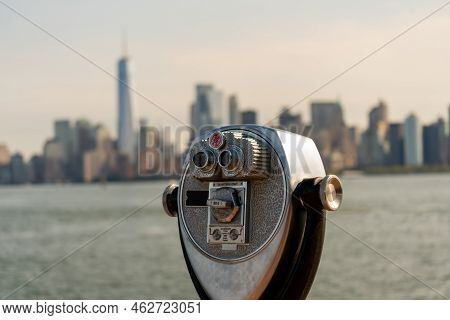 Tourist Binoculars Overlooking Downtown Manhattan From Liberty Island, New York, Usa.