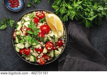 Bulgur Tabbouleh Salad With Fresh Tomatoes, Cucumbers, Parsley And Lemon Dressing. Traditional Middl