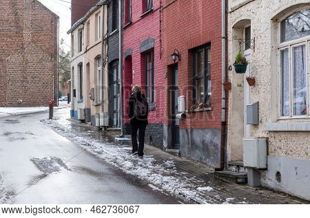 Jodoigne, Wallonia - Belgium - 01 23  2021 Thirty Year Old Woman Walking Through The Streets Of Old 