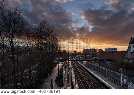 Laken, Brussels Capital Region - Belgium - 01 12 2021 Colorful Clouds Over The Railway Tracks At The