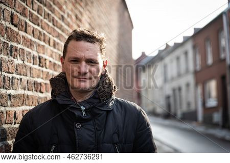 Portrait Of A Forty Year Old Man Posing In The Streets Of Old Town In Witer, Jodoigne, Belgium