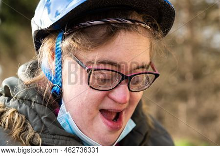 35 Year Old White Woman With Down Syndrome And Bike Helmet Laughing Outdoors, Hakendover, Belgium