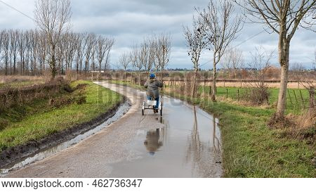 Girl With Down Syndrome Driving The Tricycle In The Flanders Fields, Hakendover, Belgium