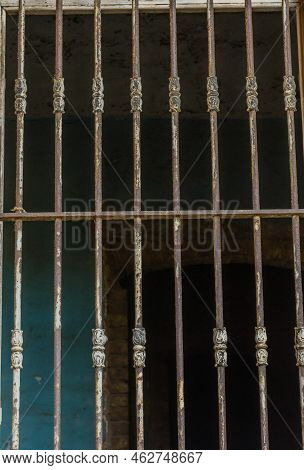 Bars Over Outside Of Glassless Window In Abandoned House.